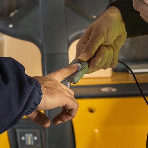 person pressing finger on scanner